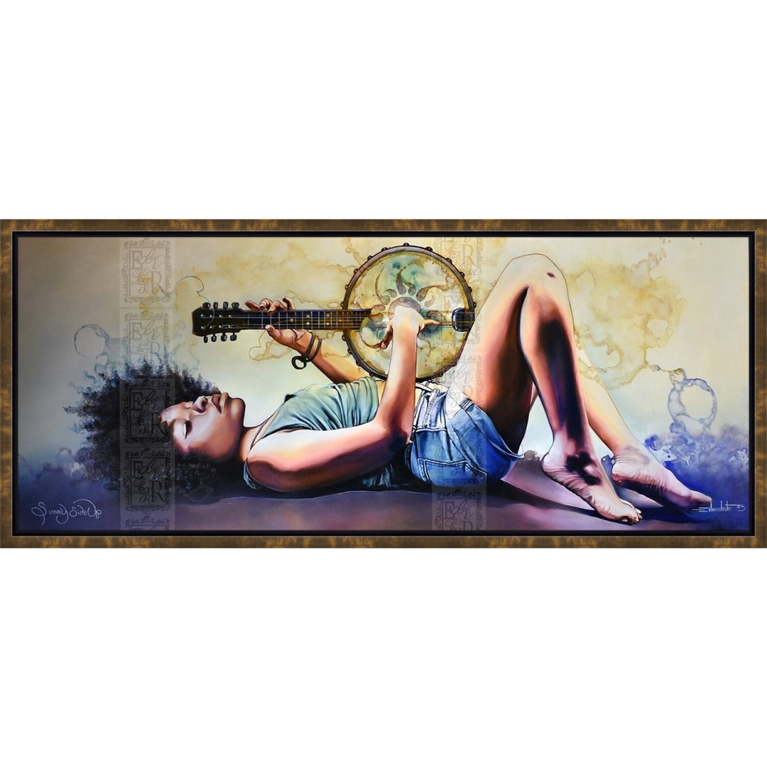 Sunny Side Up by Edwin Lester (Canvas, Bronze Floater Frame) - A framed horizontal canvas print featuring a stylized painting of a woman lying down and playing a guitar with a tambourine. The artwork has a warm beige and blue color palette with a dark brown textured frame, shown against a plain white background.