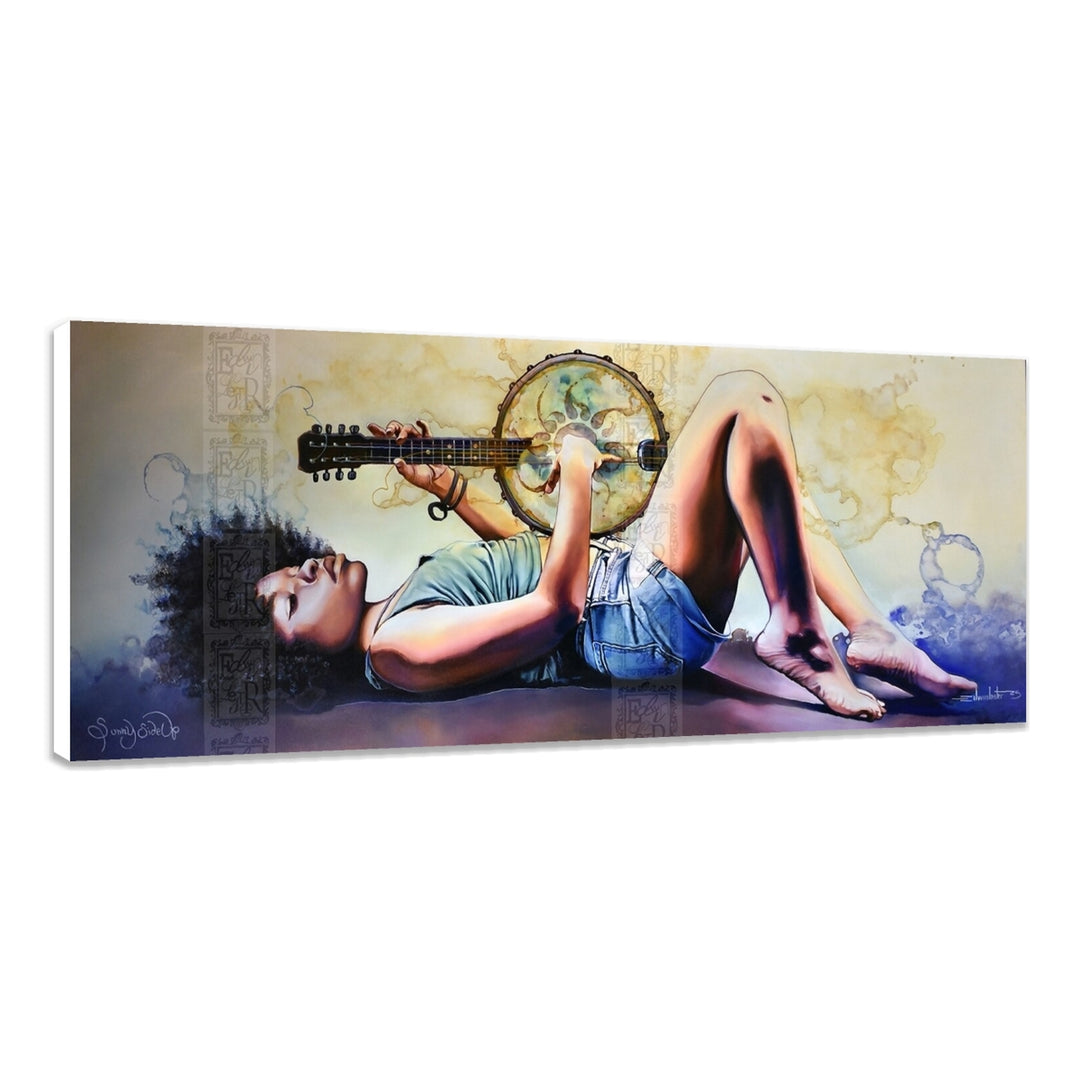 Sunny Side Up by Edwin Lester (Stretched Canvas, Unframed) - A panoramic canvas wall art print depicting a woman lying down and playing a guitar with a tambourine, shown at an angle against a white background.