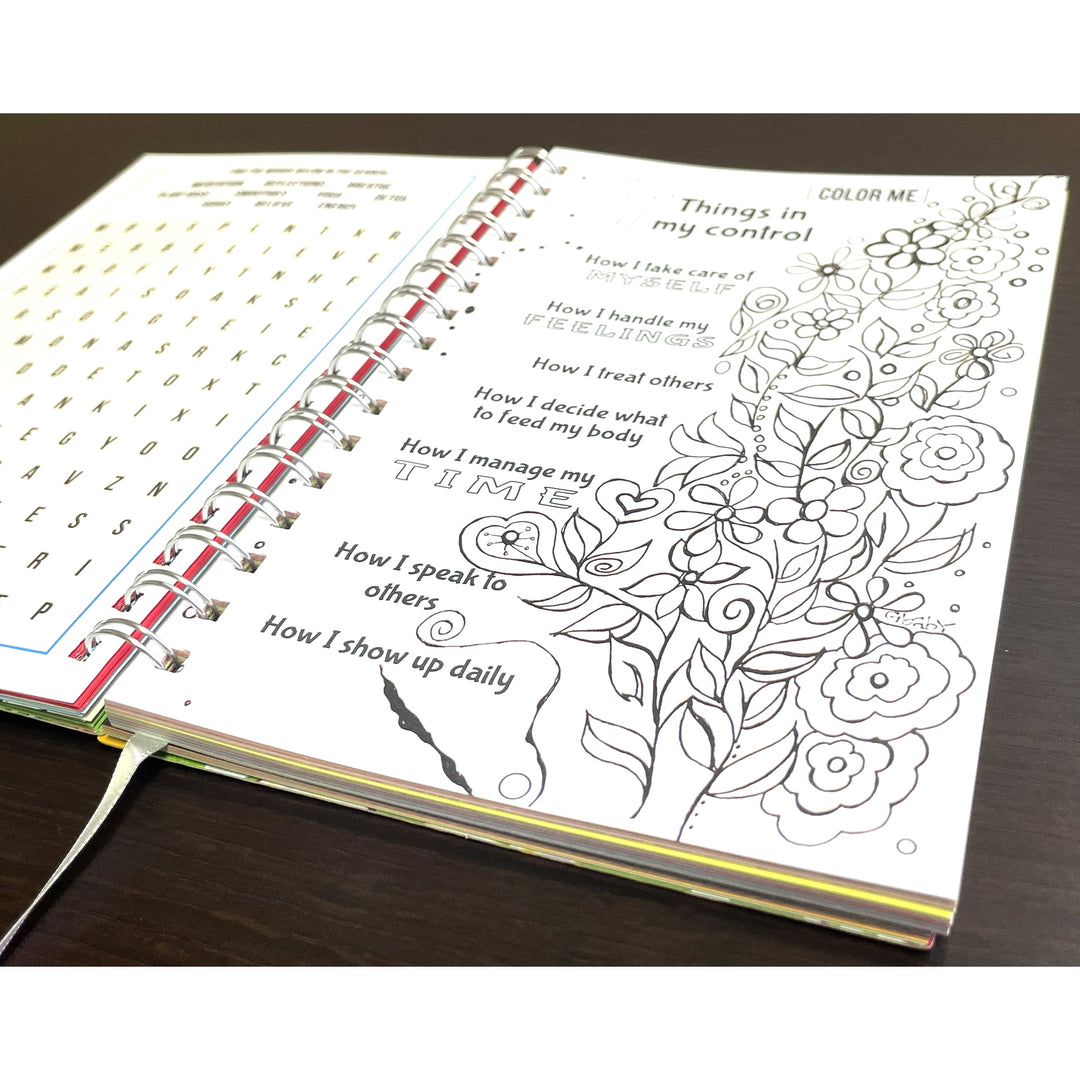 Be True to Yourself by Sylvia "Gbaby" Cohen: 2026 African American Weekly Inspirational Planner (Coloring Page) - Open coloring book with a floral design and text prompts on a wooden surface