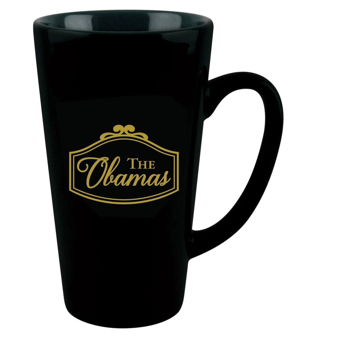 Class and Dignity: The Obamas Commemorative Ceramic Latte Mug (Rear) - A glossy black ceramic latte mug with a gold printed 'The Obamas' logo on the front, set against a plain white background.
