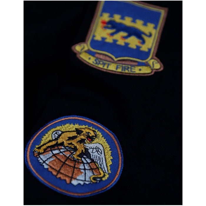 Tuskegee Airmen Squadron Patch Hooded Sweatshirt (Black, Sleeve Detail) - Two embroidered patches on a black background, one with a lion emblem and 'Spit Fire' text, the other with a panther and eagle design.