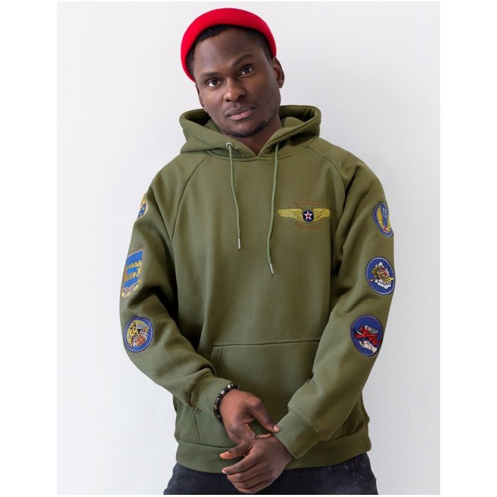 Tuskegee Airmen Squadron Patch Hooded Sweatshirt (Green, Lifestyle, Front) - Person wearing a green hoodie with patches on a white background