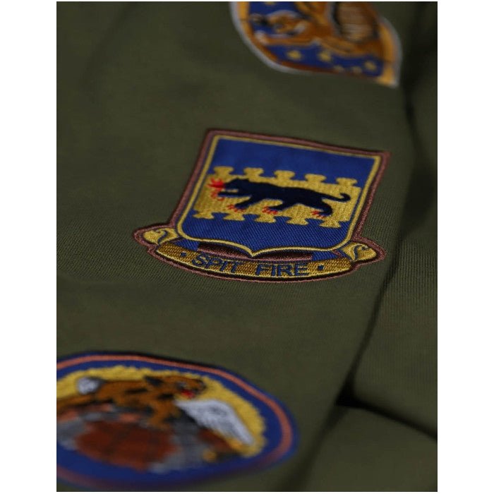 Tuskegee Airmen Squadron Patch Hooded Sweatshirt (Green, Sleeve Detail) - Close-up of a military uniform with various patches on a green background